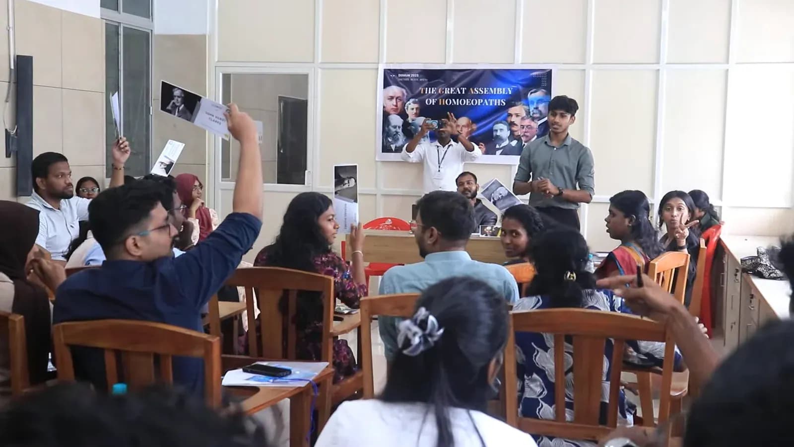 Press photographers capturing floor debate at DIIMUN