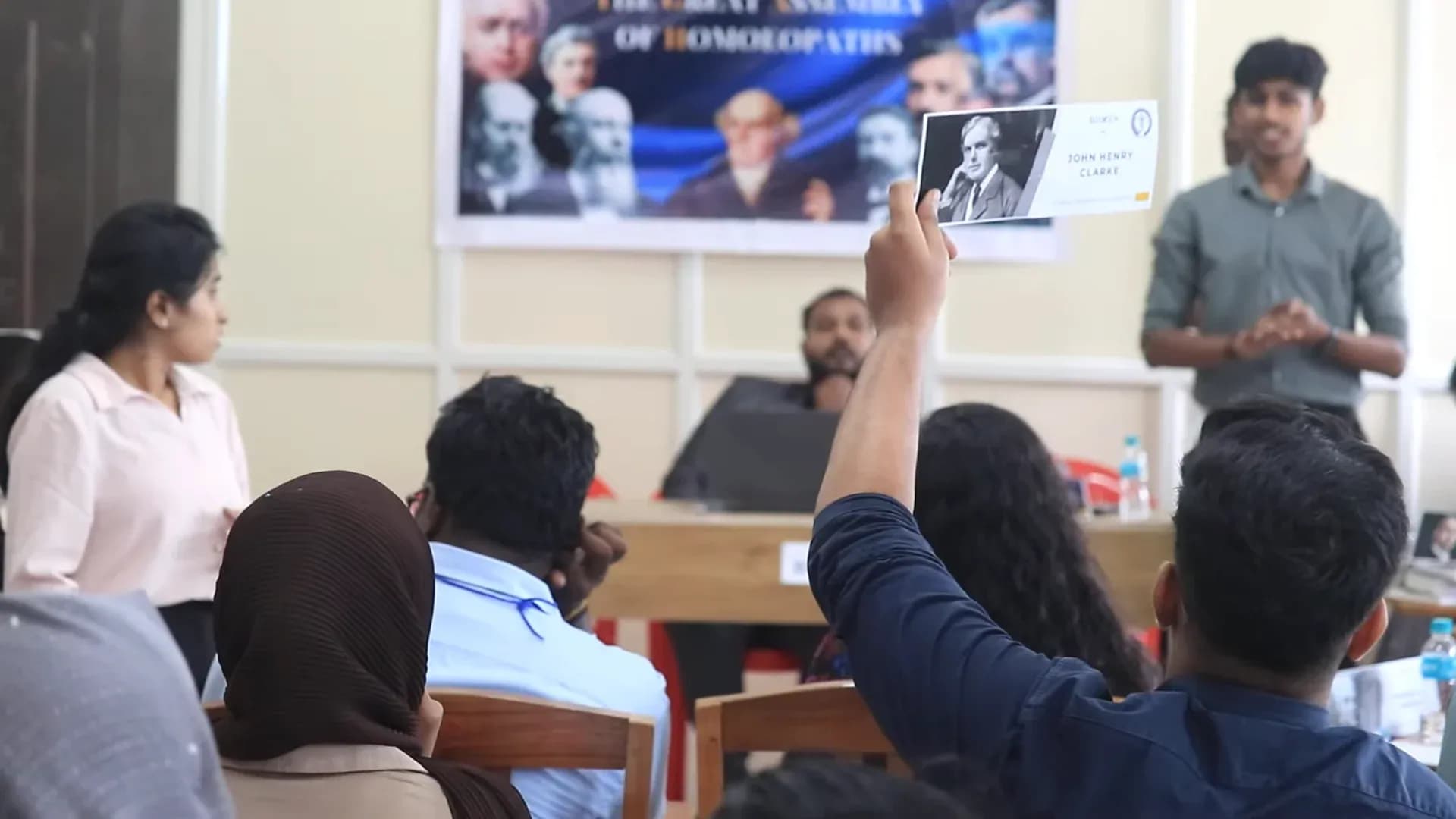 Authentic DIIMUN debate session with delegate raising stalwart placard