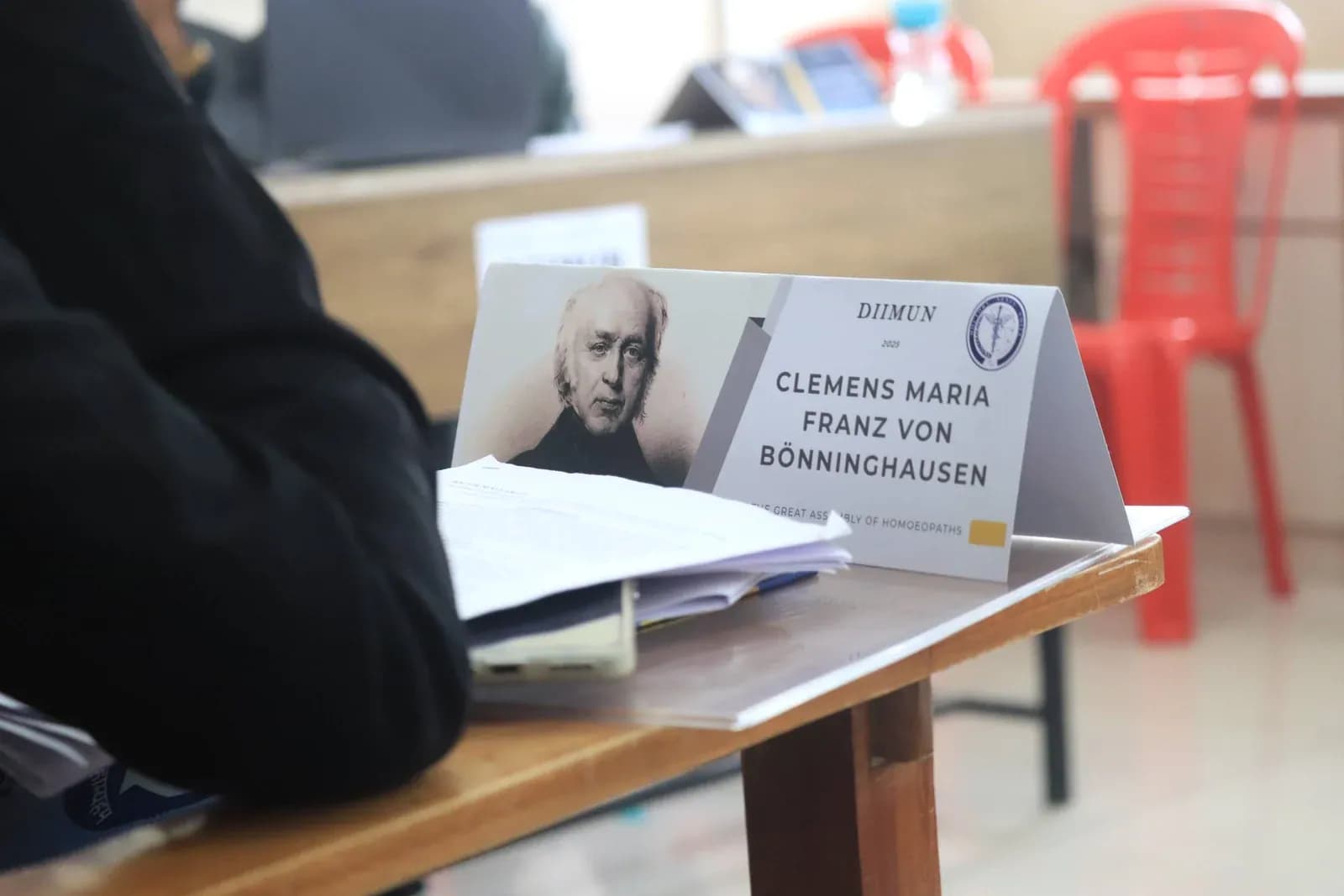 Printed dossiers, delegate kit, and stalwart placard at DIIMUN